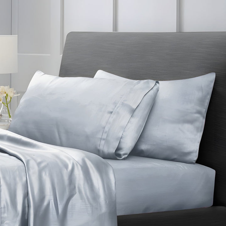 Overhead view of silver grey cotton sheet set with folded top sheet and pillows
