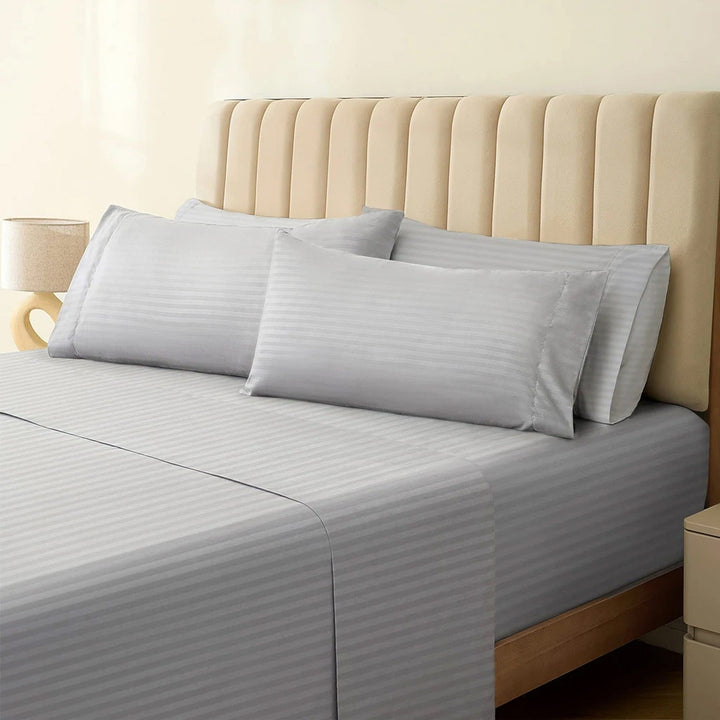 1500TC cotton rich silver gray striped sheet set neatly dressed on a bed with matching pillowcases