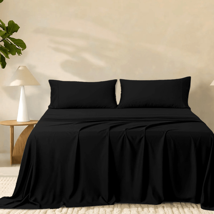 2000TC super soft bamboo sheet set in solid black styled on a bed with two matching pillowcases.