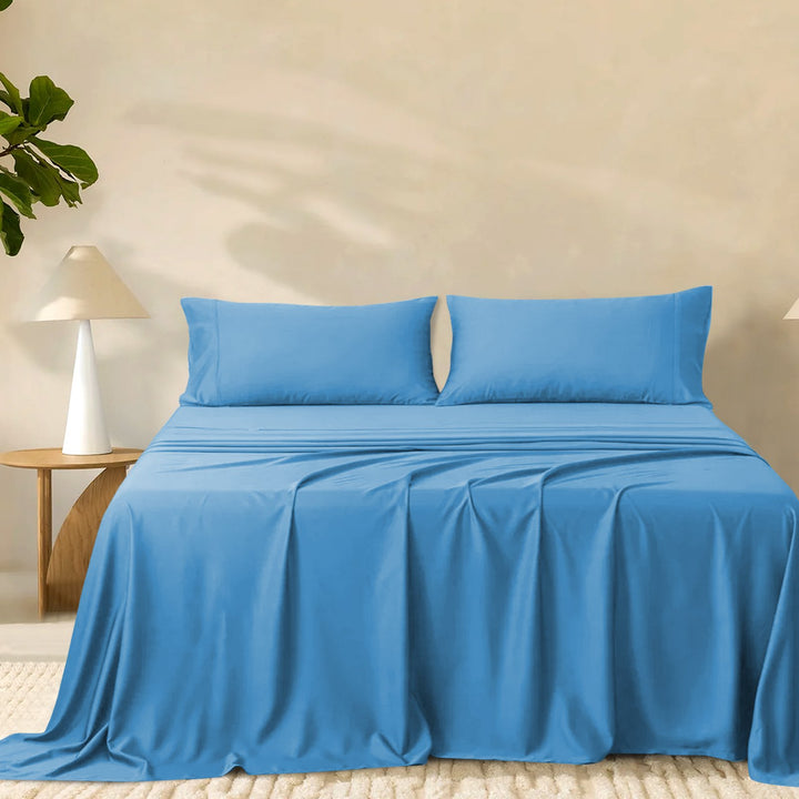 2000TC super soft bamboo sheet set in vibrant blue styled on a made bed with matching pillowcases