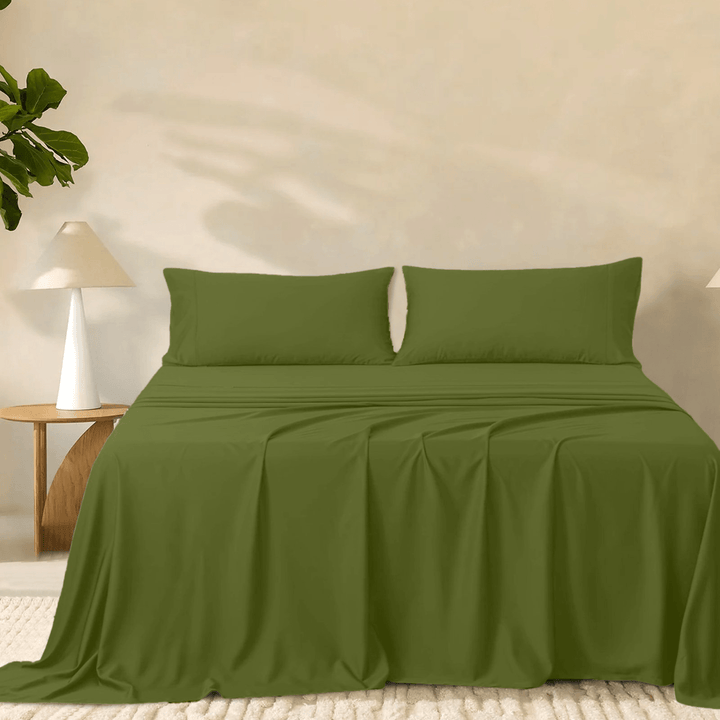 2000TC super soft bamboo sheet set in rich olive green styled on a bed with two matching pillowcases