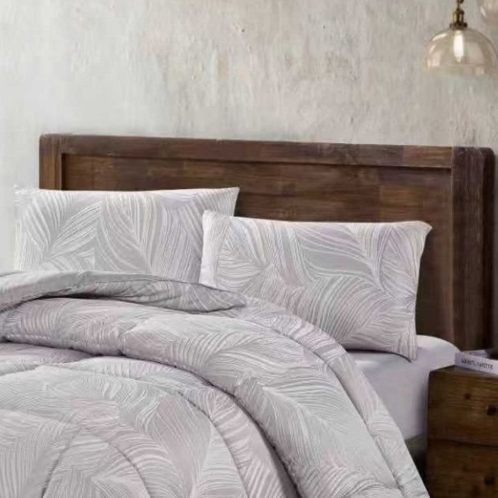 Full view of light grey botanical jacquard comforter and matching pillow shams