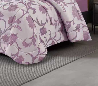 Full view of light purple floral jacquard comforter with matching pillow shams in an elegant bedroom