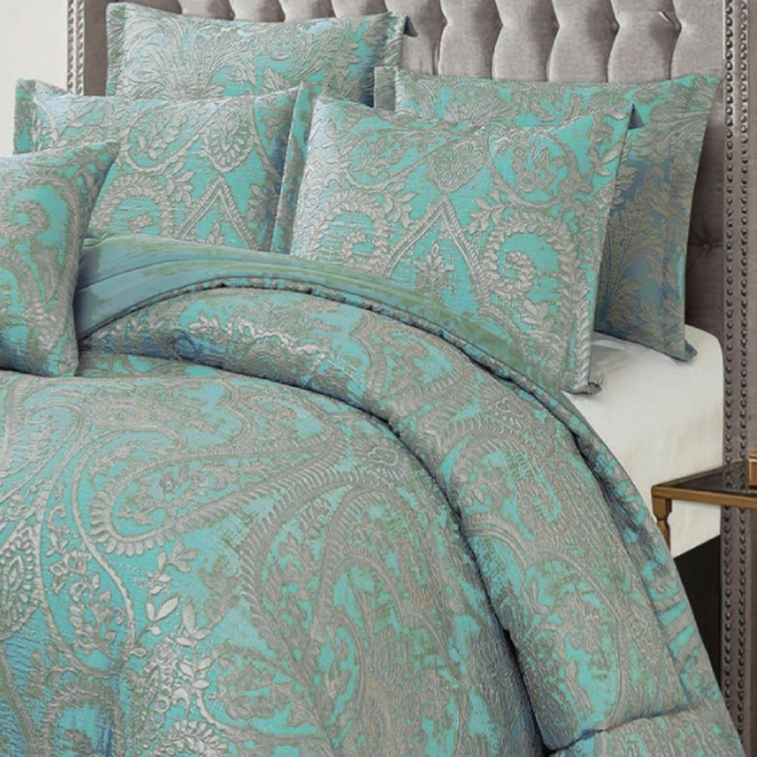 Full view of luxury teal and silver jacquard comforter with matching pillows in an elegant bedroom
