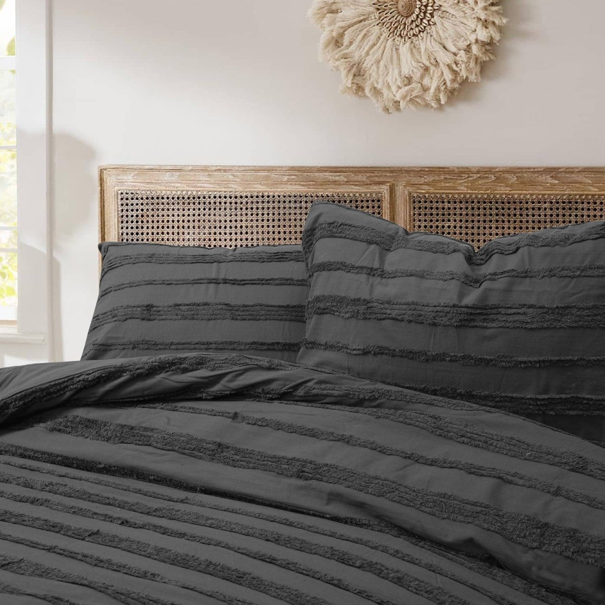 Textured black quilt cover with matching pillowcases.