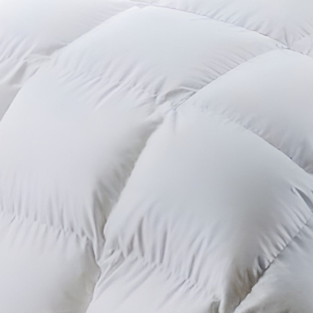 Soft and fluffy white cotton quilt providing warmth and comfort.