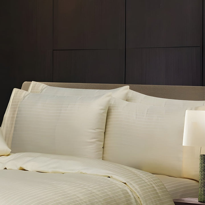 Soft ivory cotton bedding with subtle stripe patterns and matching pillowcases
