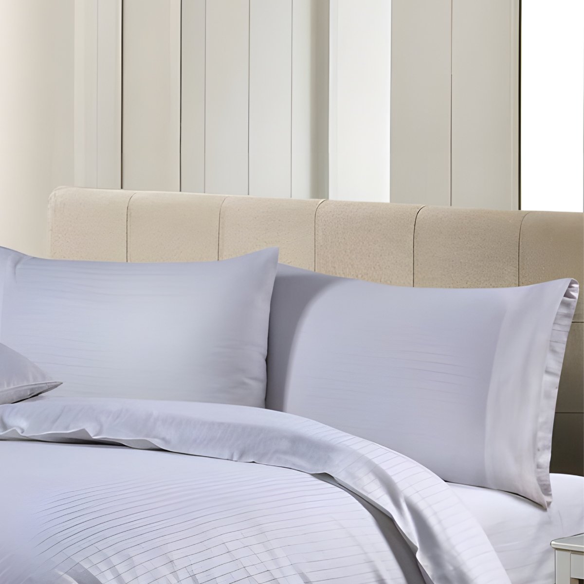 Full view of classic white striped duvet cover and matching pillowcases in a modern bedroom setting.