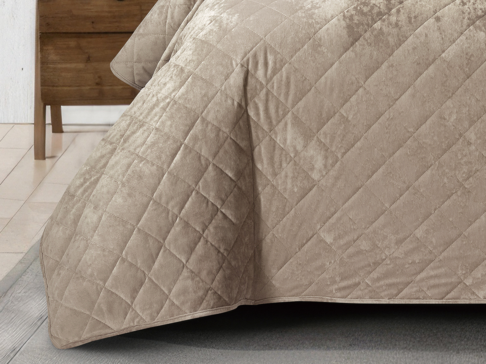 Soft tan velvet bed cover with matching pillows in a sophisticated bedroom.