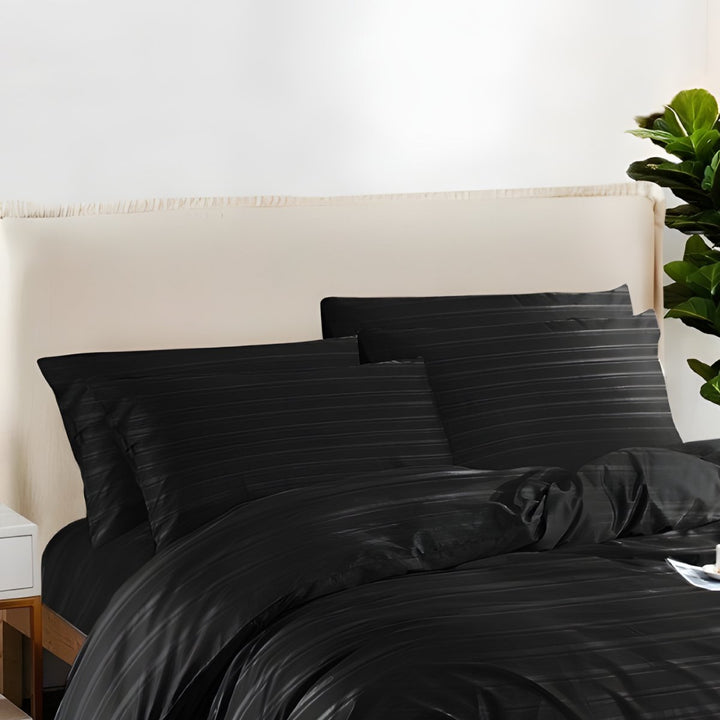 Soft black bedding with subtle stripe patterns and matching pillowcases