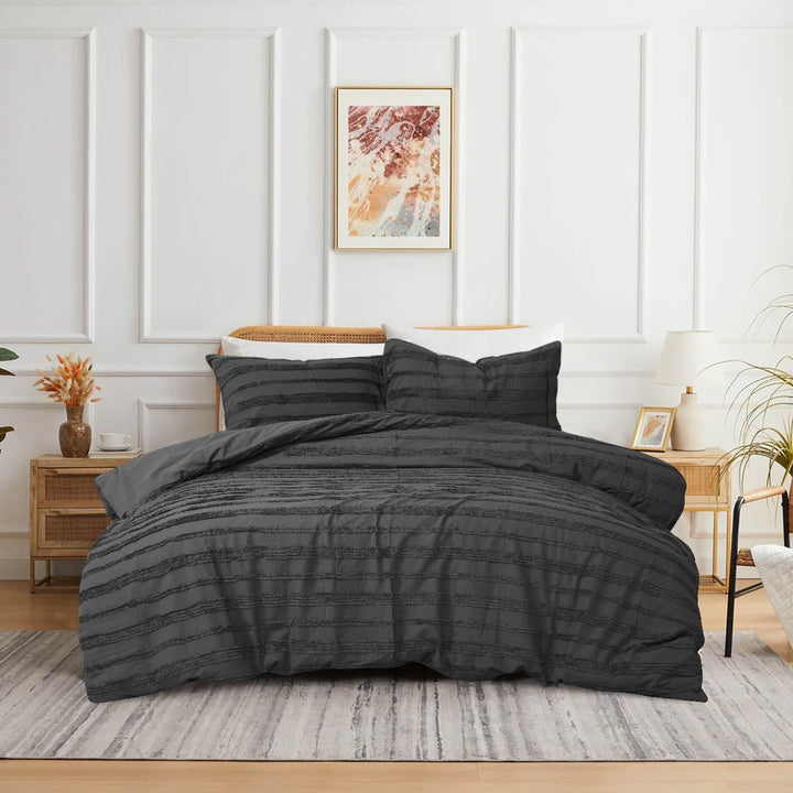 Black 3-piece tufted quilt cover set on a modern bed.