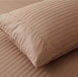 Detailed view of the woven stripe pattern and silky finish on brown cotton blend bedding