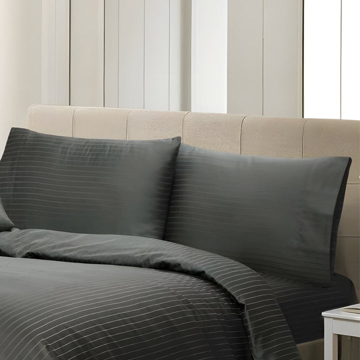 Soft charcoal cotton bedding with delicate pinstripe patterns and matching pillows.