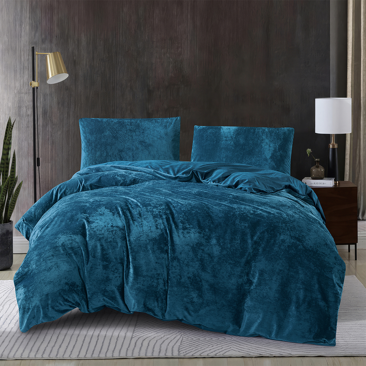 Dark teal blue 3-piece crushed velvet quilt cover set displayed on a modern bed.