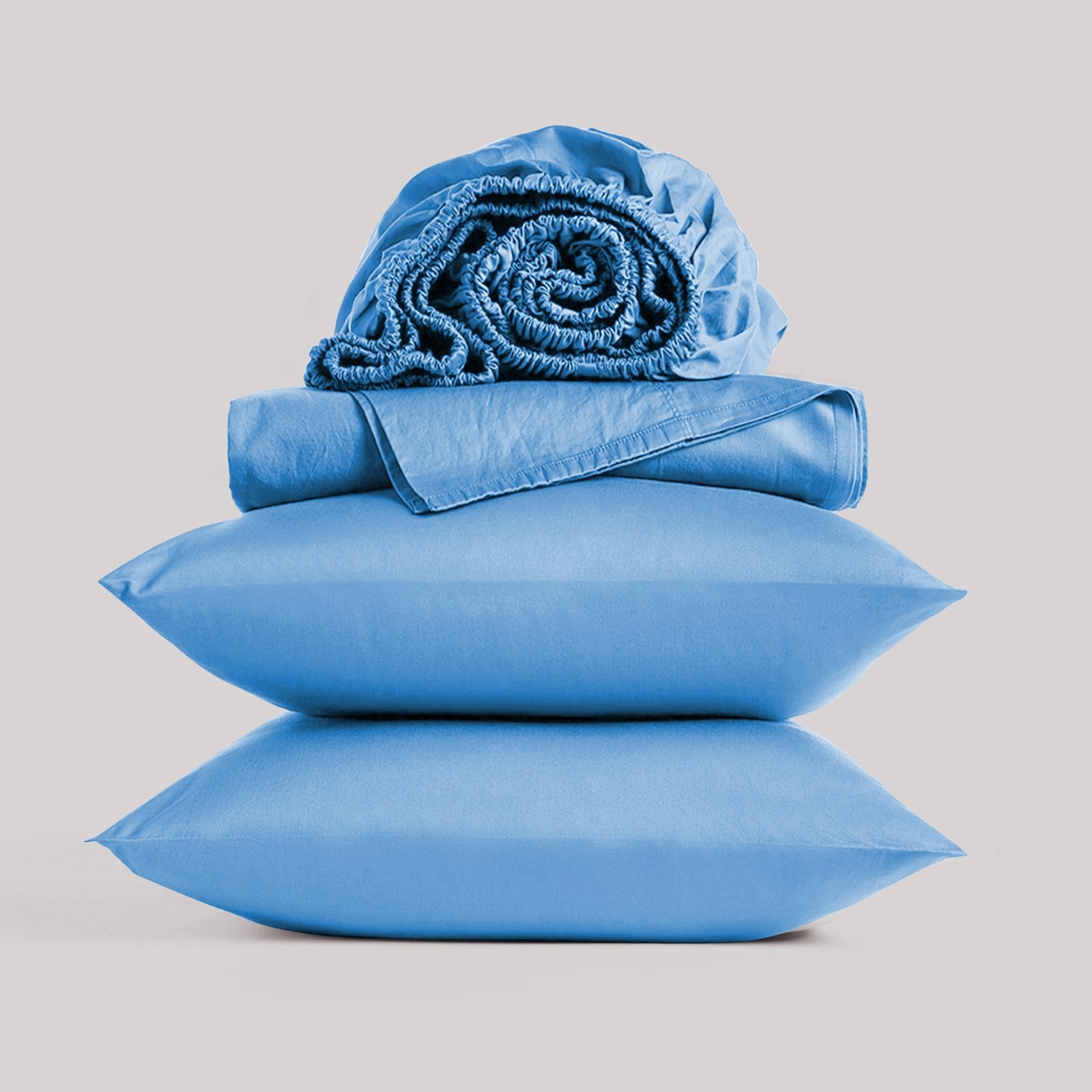 Full view of a luxury blue bamboo sheet set cleanly styled in a contemporary, sunlit bedroom.