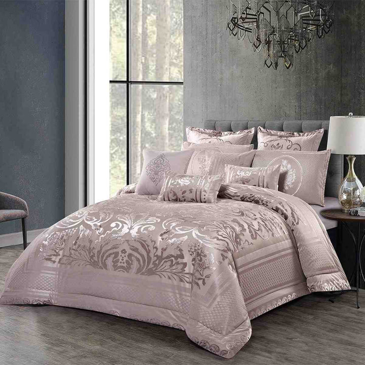 Dusty pink damask bedding gift set featuring intricate floral patterns and matching decorative pillows on a luxury bed.