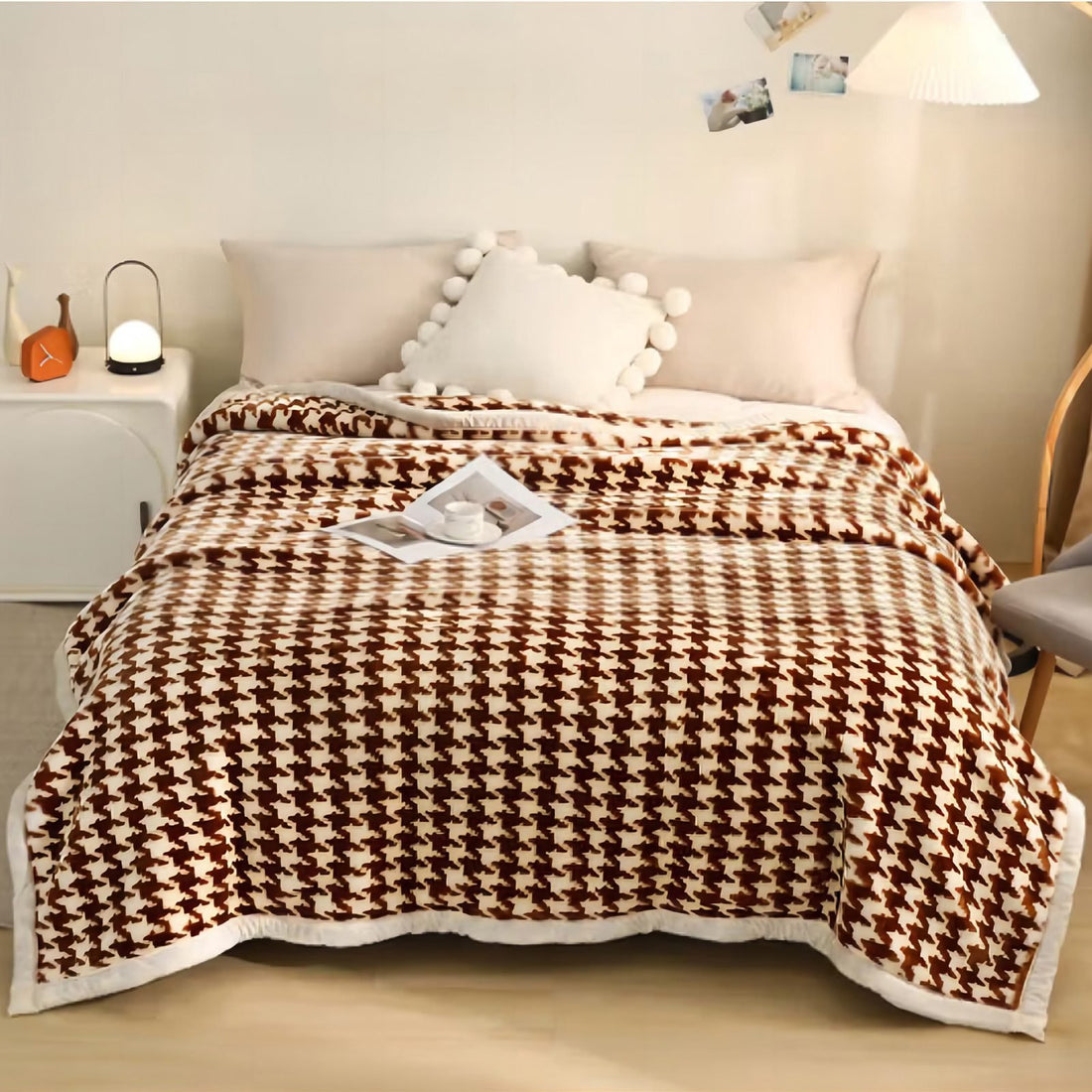 Super soft 3kg brown and cream houndstooth mink blanket neatly draped over a bed with decorative pillows