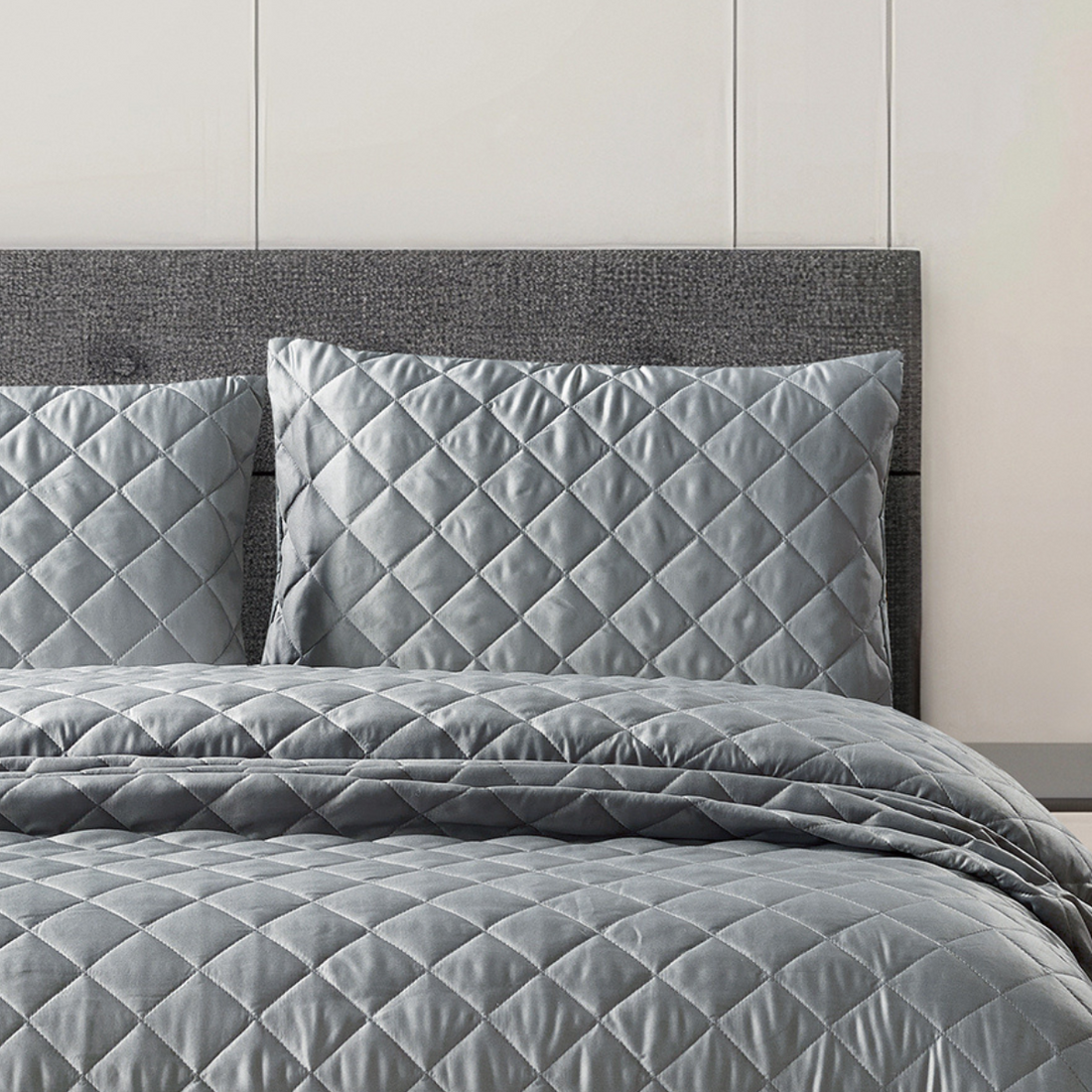 Luxury silver bedspread featuring an elegant diamond stitched pattern.