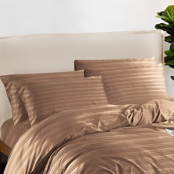 Soft mocha brown bedding with subtle stripe patterns and matching pillowcases.
