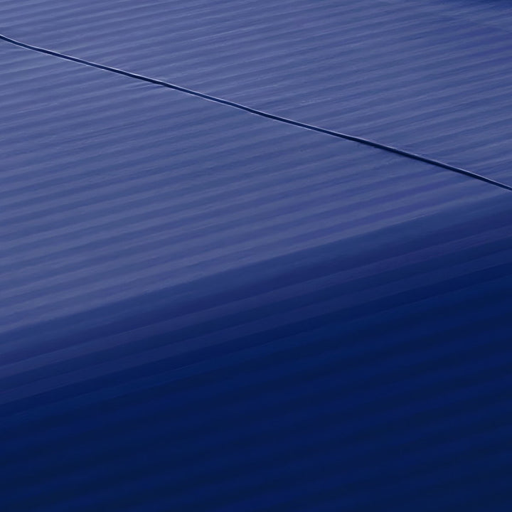 Close-up perspective of the smooth satin stripe weave of a deep navy blue cotton rich fitted sheet