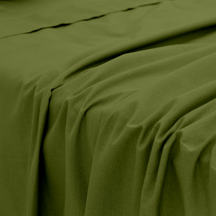 Close-up perspective of the smooth, fluid fabric folds and texture of an olive green bamboo bed sheet