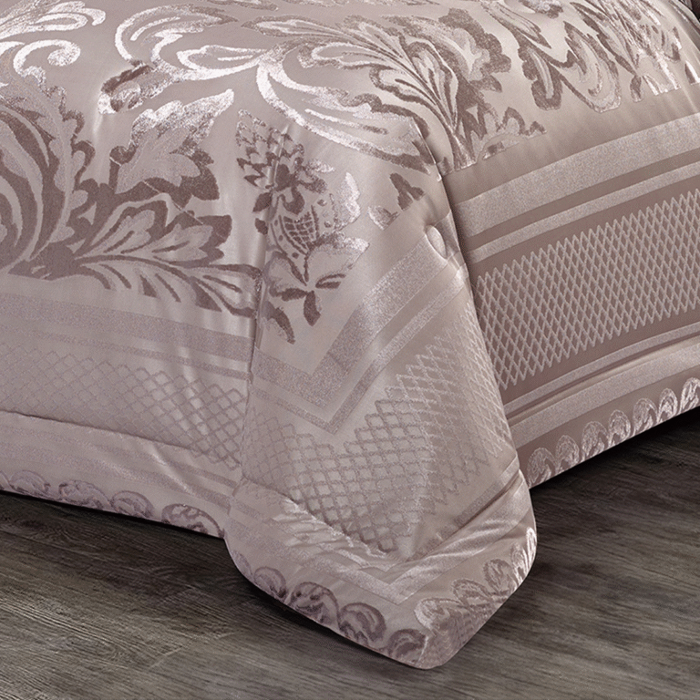 Luxury pink damask bedspread showcasing detailed patterns and decorative borders in a stylish bedroom.