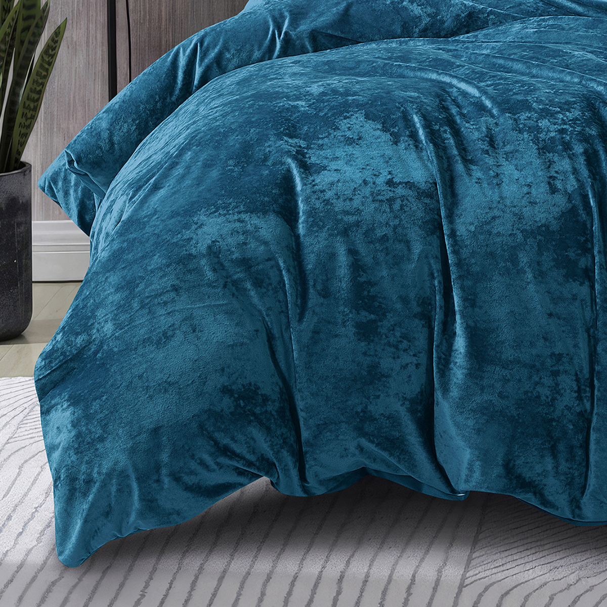 Close-up of plush dark teal velvet quilt cover fabric.