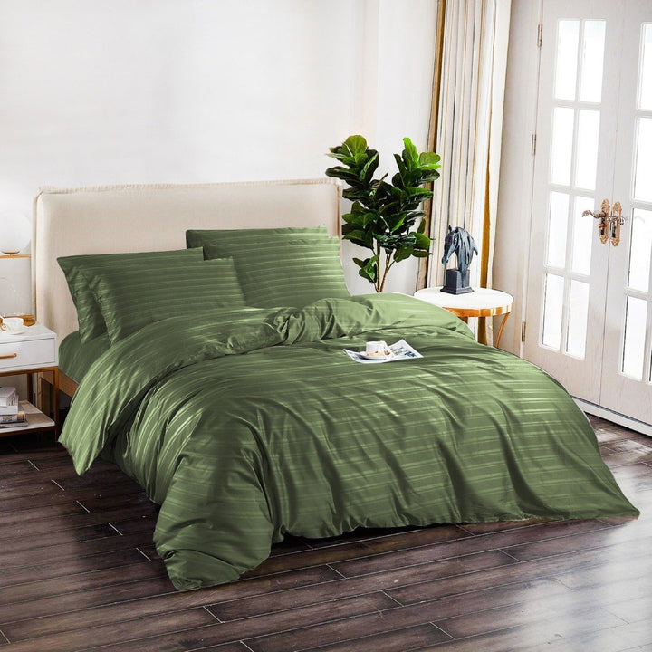 Sage green 6-piece cotton quilt cover set styled on a modern bedroom bed.