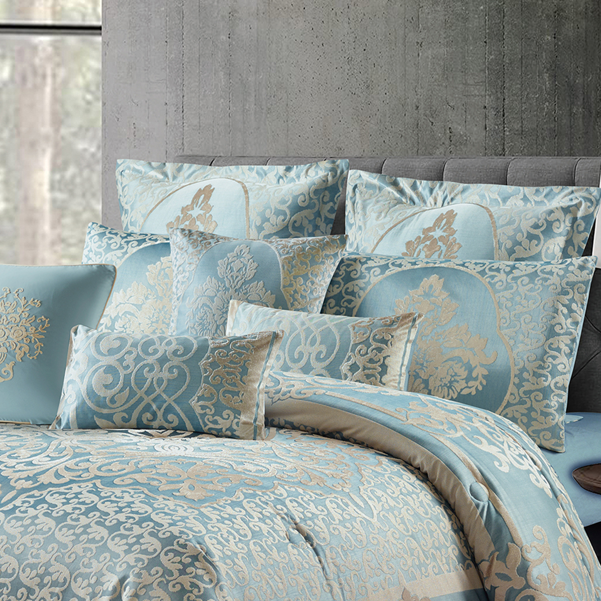 Elegant silver blue floral bedspread with ornate damask patterns displayed in a modern bedroom.