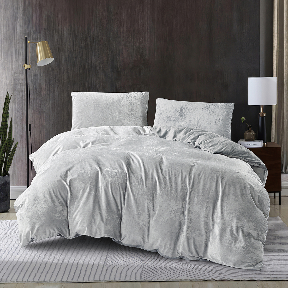 Silver 3-piece crushed velvet quilt cover set displayed on a modern bed.