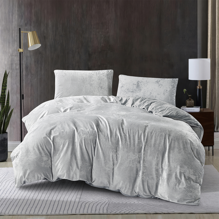 Silver 3-piece crushed velvet quilt cover set displayed on a modern bed.