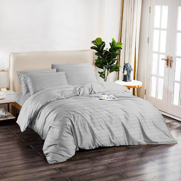 Silver grey 6-piece cotton quilt cover set styled on a modern bedroom bed.