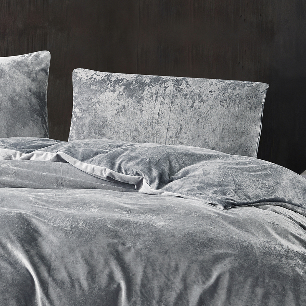 Grey crushed velvet bedding set styled in a luxurious bedroom.