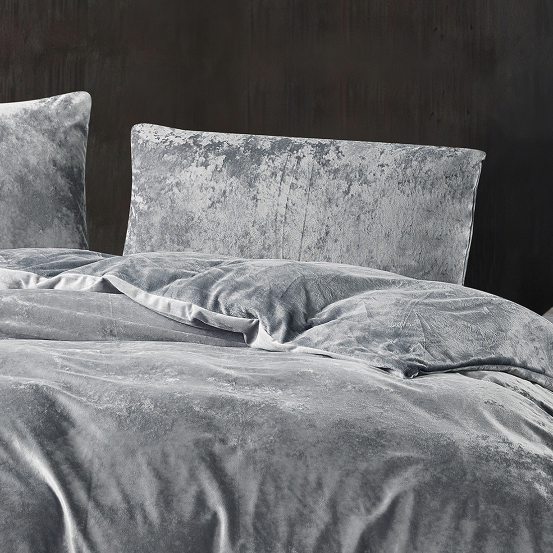 Grey crushed velvet bedding set styled in a luxurious bedroom.
