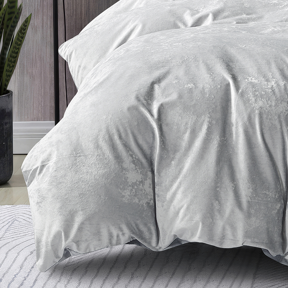 Silver crushed velvet bedding set styled in a luxurious bedroom.