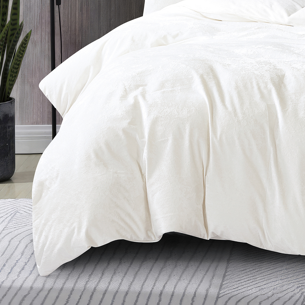 Close-up of soft, textured white velvet quilt cover fabric.