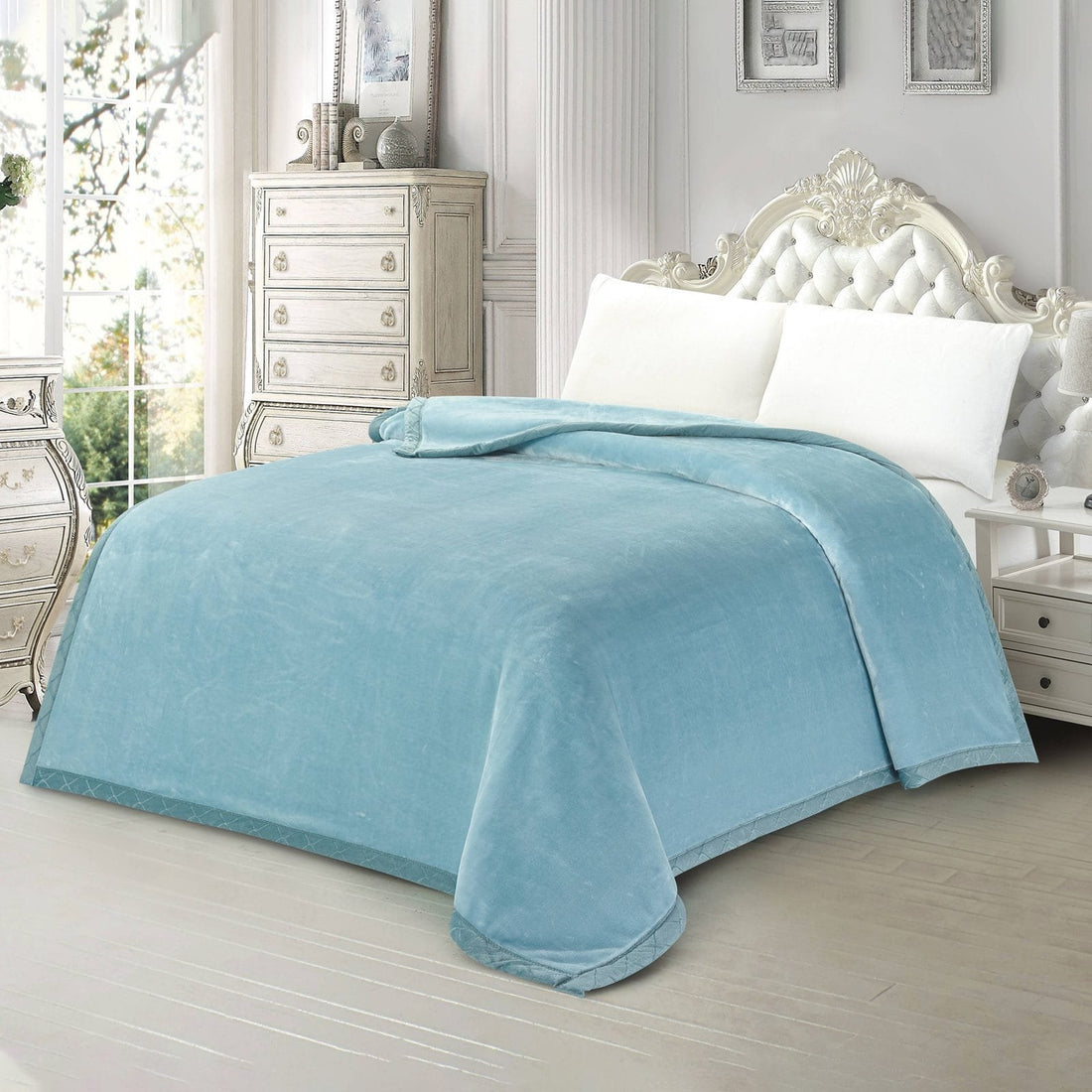 Side perspective of a plain light blue plush mink blanket styled in an elegant vintage bedroom setting.