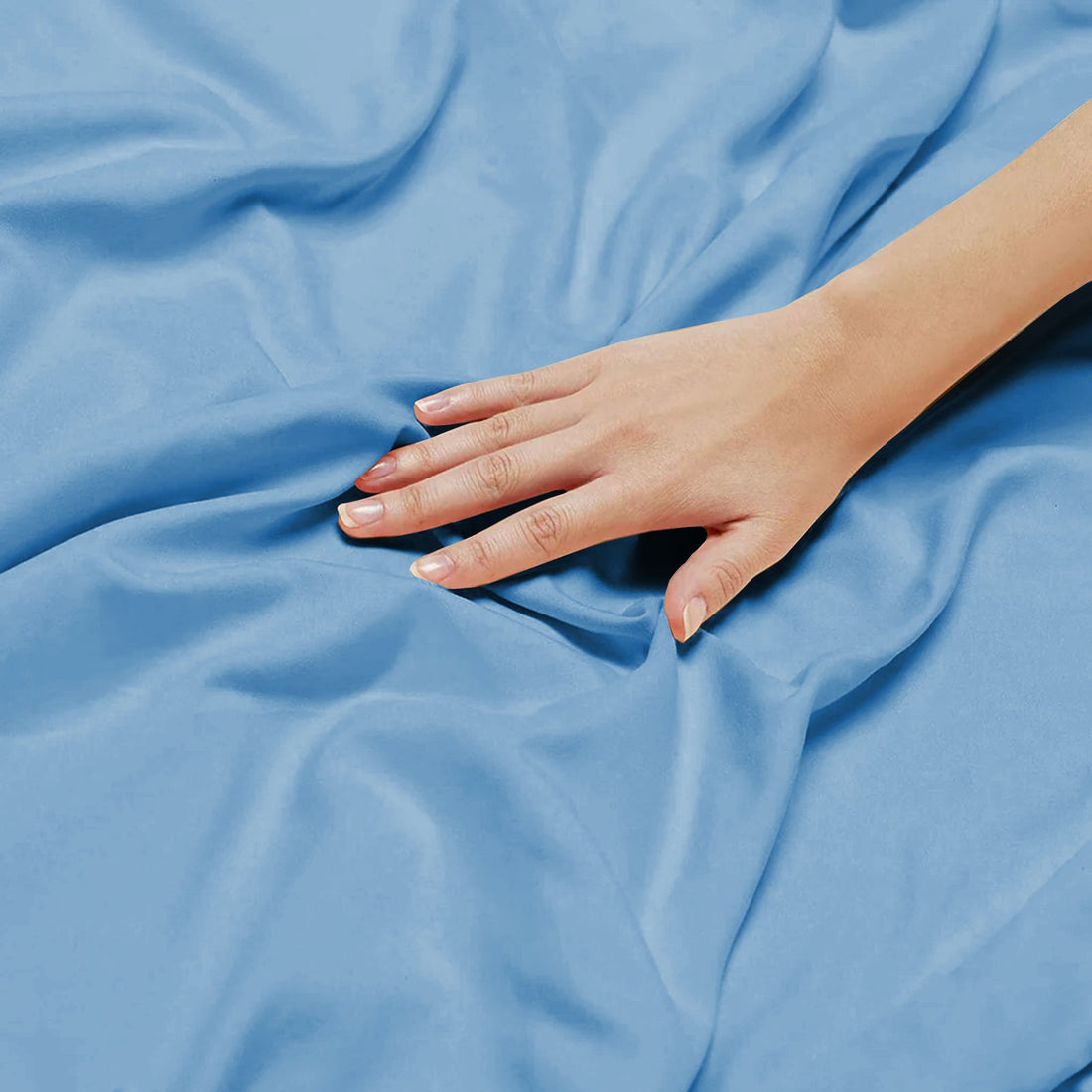 Detailed close-up showing the soft, silky drape and texture of breathable blue bamboo bedding