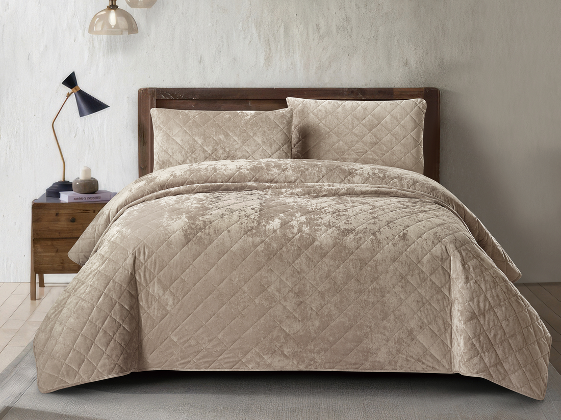 Luxury tan crushed velvet bedspread set styled on an elegant bedroom bed.