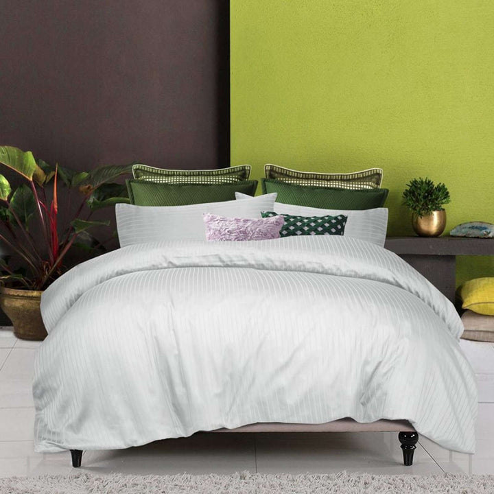 White 6-piece pure cotton striped quilt cover set styled on a modern bed.