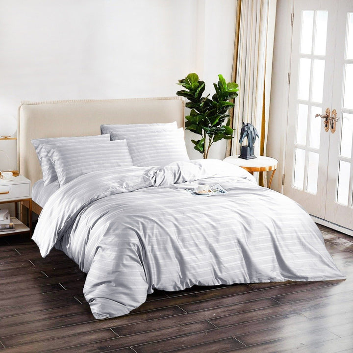 White striped cotton quilt cover set styled on a modern bedroom bed.