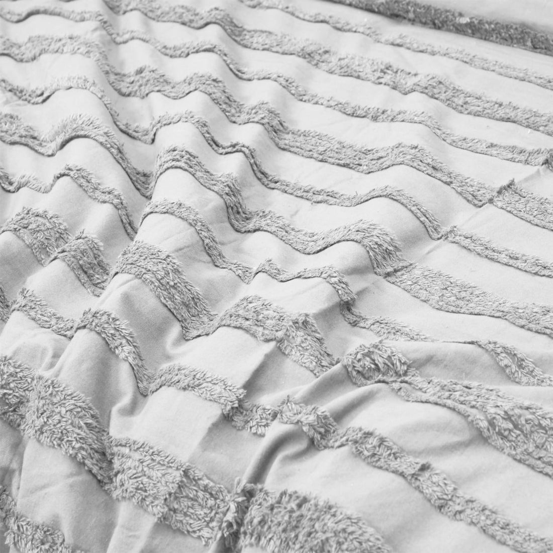 White tufted bedding set in a stylish bedroom.