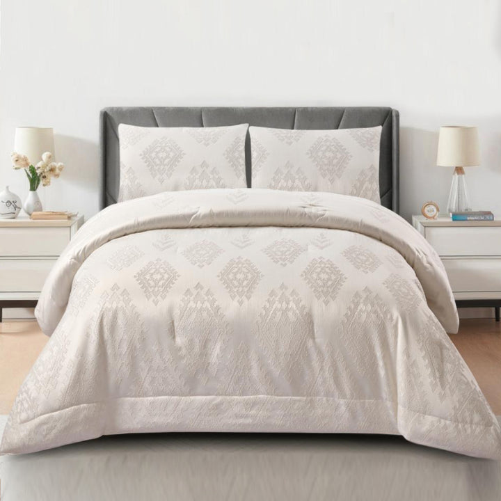 3-piece white jacquard comforter set with beige geometric diamond patterns on a queen bed