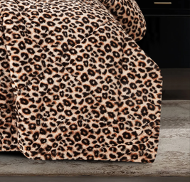 Full view of fluffy animal print faux fur comforter and matching pillow shams in a bedroom setup