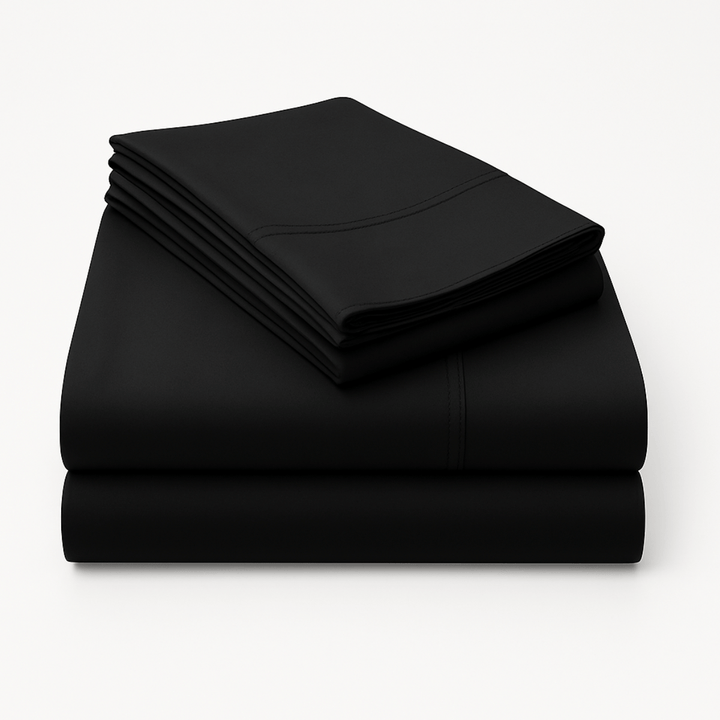 Folded black cotton sheets stacked neatly