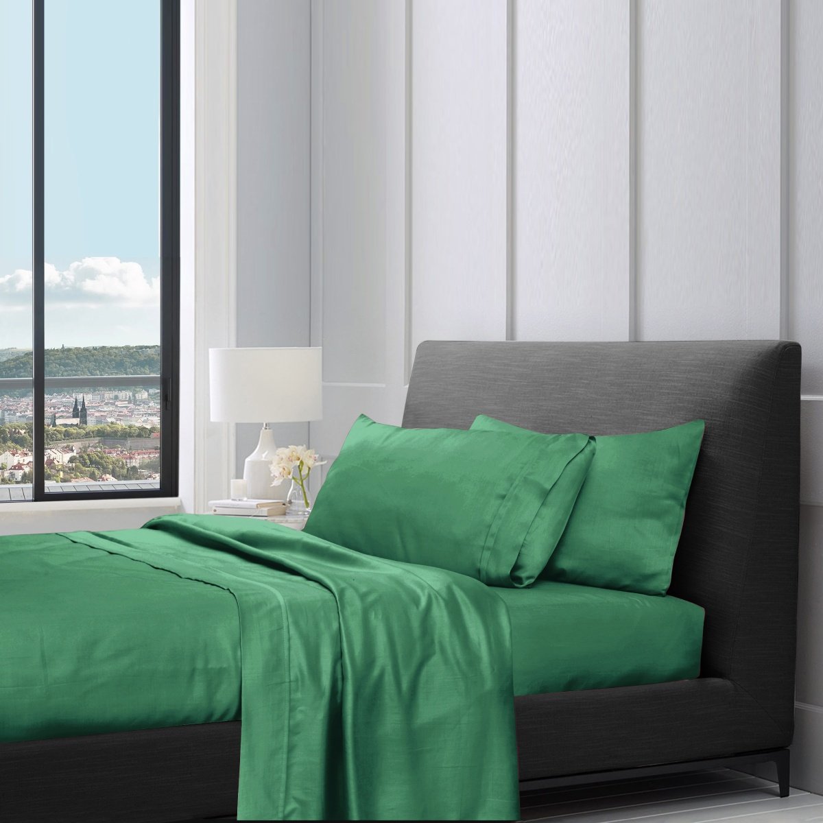 1200TC pure cotton sheet set in brunswick green styled on a bed with pillows