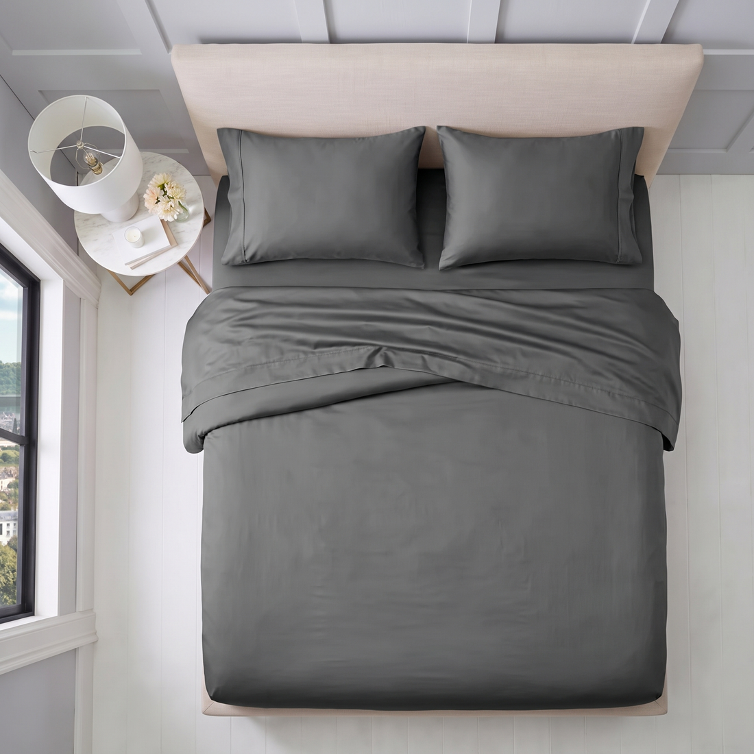 Overhead view of charcoal cotton sheet set with matching pillowcases and folded top sheet