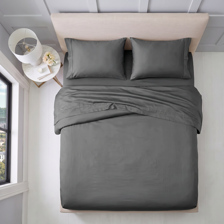 Overhead view of charcoal cotton sheet set with matching pillowcases and folded top sheet