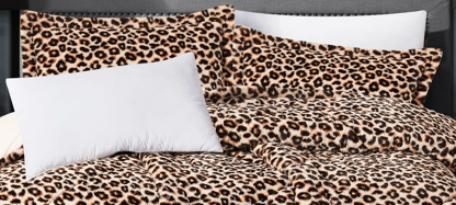 "Close-up of soft plush leopard pattern faux fur fabric highlighting its texture and spot details.