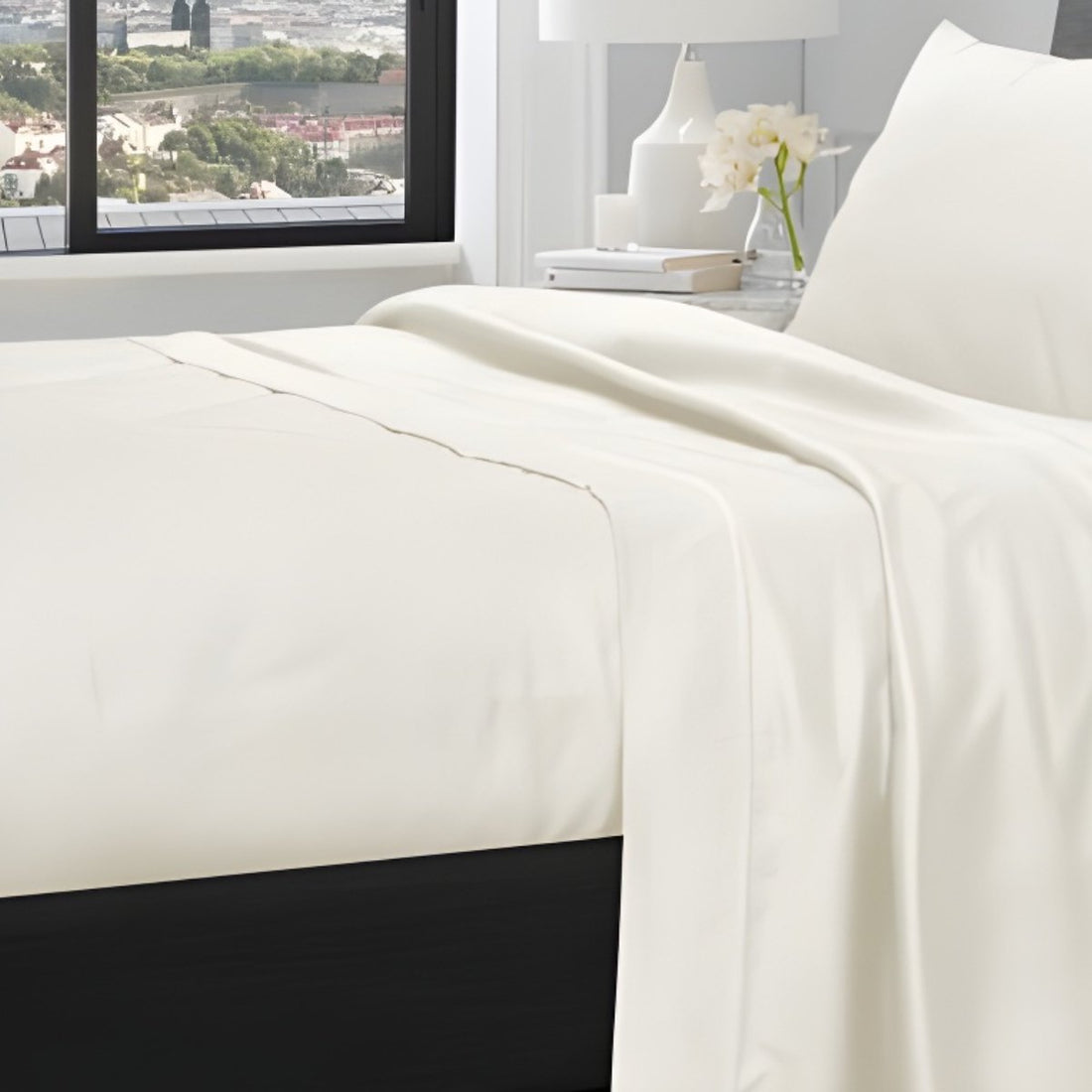 Close-up of cream pillowcases showing soft cotton fabric texture and stitched trim